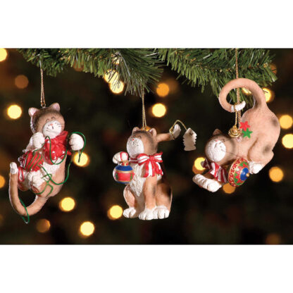 Three cat ornaments each wearing a different colored bow.